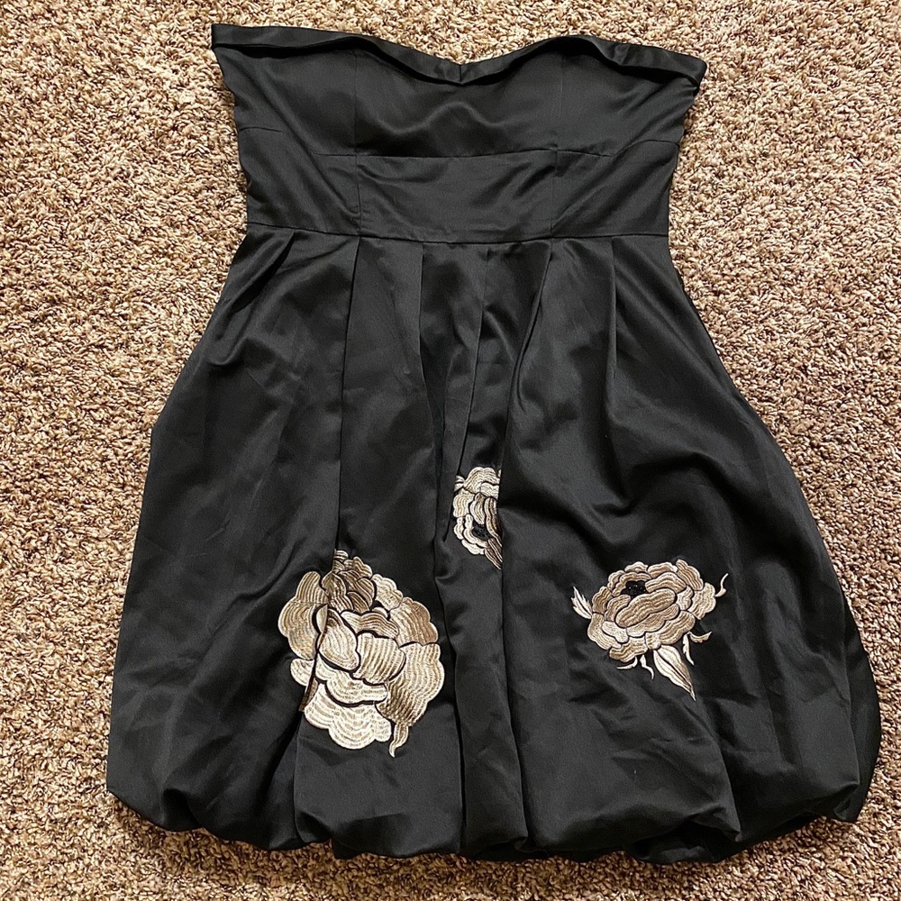 Sleeveless black dress with flower embellishments
